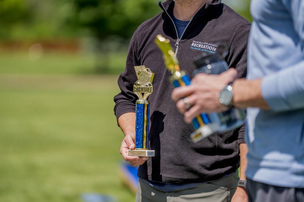 Members of the winning team hold their blue trophies